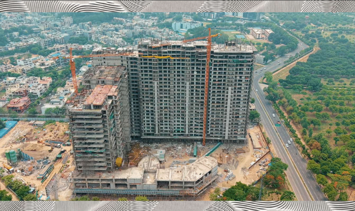 A couple looking at the rising towers of Homeland Regalia Mohali under construction, symbolizing future dreams.