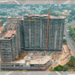 A couple looking at the rising towers of Homeland Regalia Mohali under construction, symbolizing future dreams.