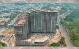 A couple looking at the rising towers of Homeland Regalia Mohali under construction, symbolizing future dreams.